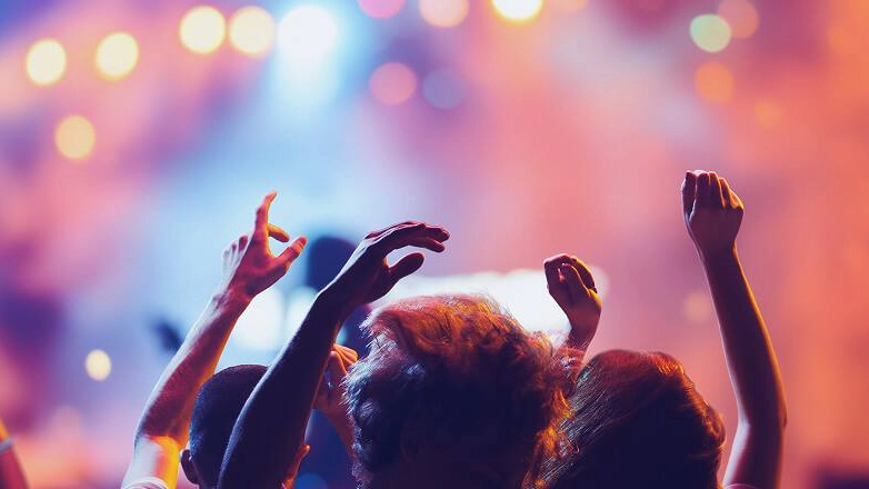 People cheering at a concert