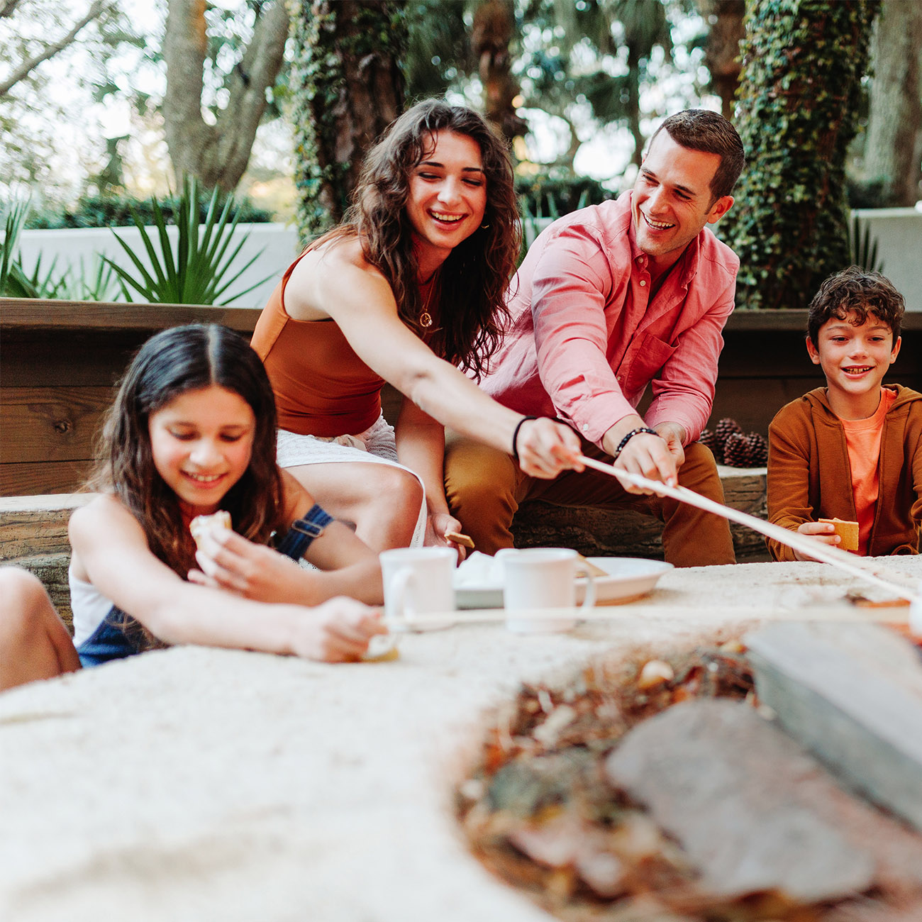 Family at a campfire making smores