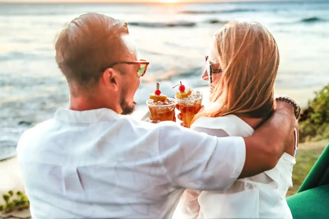 Couple enjoying cocktails on the beach